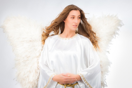 Woman in angel costume with artificial feather wings isolated on white background spirituality purity dreams religionの写真素材