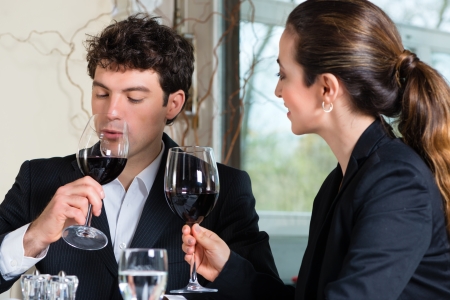 Businesspeople having business lunch in a fine dining restaurantの写真素材