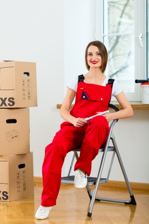 Young woman in overall renovated the apartment because she moved to their new or old homeの写真素材