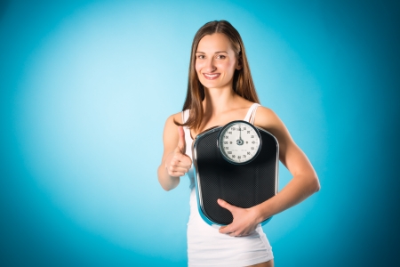 young woman with a scaleの写真素材