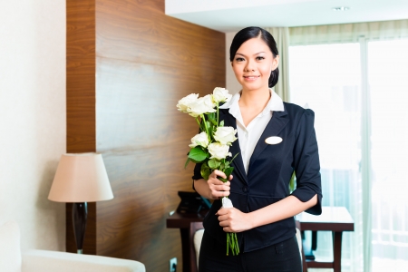Hotel Manager or director or supervisor welcome arriving VIP guests with roses on arrival in luxury or grand hotelの写真素材