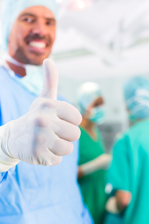 Hospital - surgery team in the operating room or Op of a clinic operating on a patient, perhaps it's an emergencyの写真素材