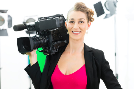 Camerawoman or Cameraman or shooting  with digital camera on film set or video production for TV or...