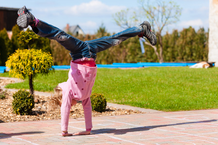 Girl playing in the garden having fun in spring