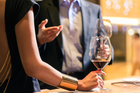 Midsection view of couple chatting in a wine shop