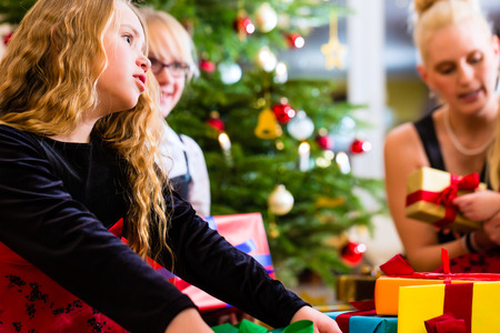 Mother and children with presents on Christmas dayの写真素材
