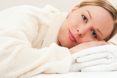 Woman in bathrobe relaxing in a spa situationの写真素材