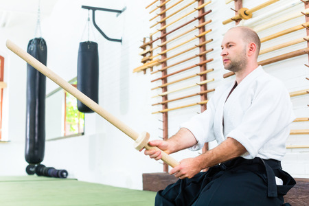 Man at Aikido martial arts with wooden swordの写真素材