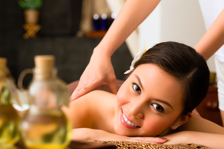 Chinese Asian woman in wellness beauty spa having aroma therapy massage with essential oil, looking relaxedの写真素材