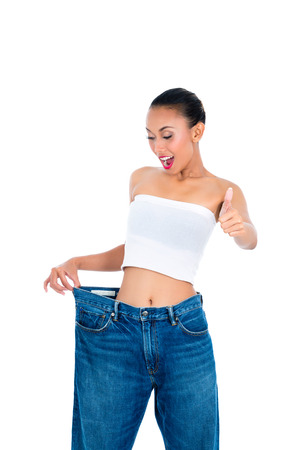 Young Asian woman losing weight by living healthyの写真素材