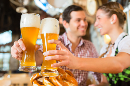 Couple drinking wheat beer in bavarian restaurantの写真素材