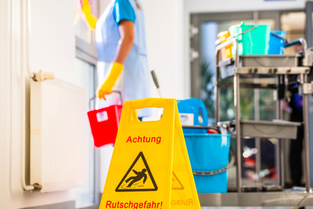 Warning sign on floor in cleaning operationの写真素材