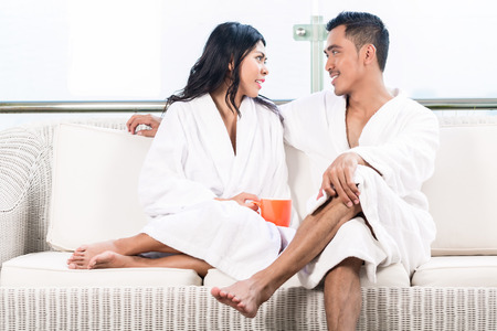 Couple in morning sitting on couchの写真素材