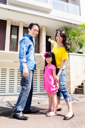 Chinese Family in front of house in residential area in Asiaの写真素材