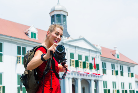 Woman tourist taking pictures of old colonial quarter in Jakarta, Indonesiaのeditorial素材