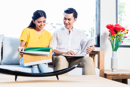 Couple in furniture store showroom choosing colors and material, Asian woman and manの写真素材