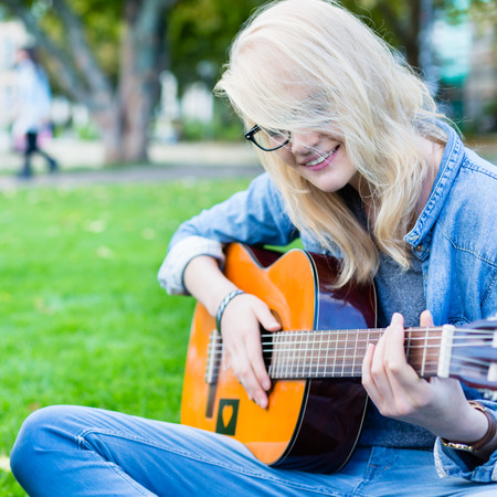 Friends singing songs in park having fun togetherの写真素材
