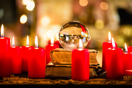 Crystal ball to prophesy or esoteric clairvoyance during a Seance in the candle light