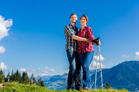 Couple enjoying view hiking in the alpine mountainsの写真素材