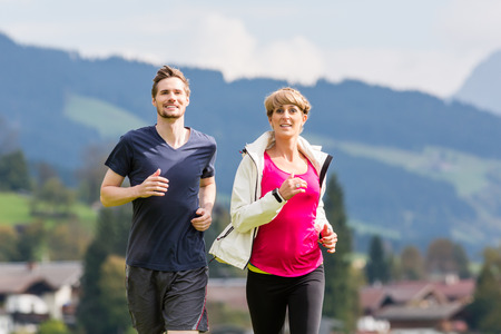 Couple doing sport running in the mountainsの写真素材