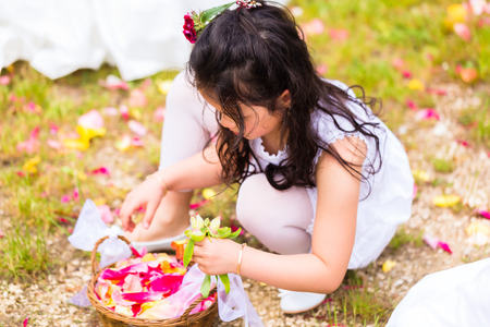 Wedding couple bride and groom with flower children or bridesmaid in white dress and flower basketsの写真素材