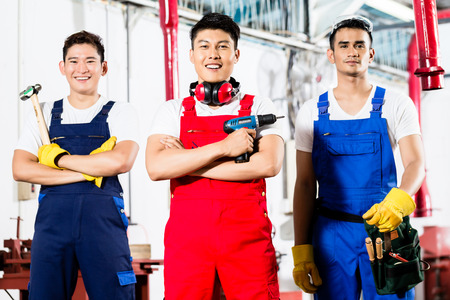 Team of Workers with tools in Asian industrial factoryの写真素材