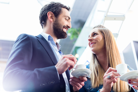 Man flirting with woman while drinking coffeeの写真素材