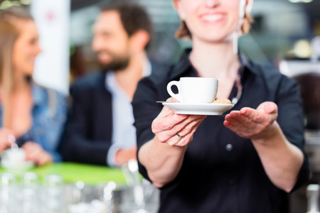 Barista presenting espresso in cafeの写真素材