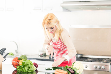Asian woman cooking food in very modern kitchenの写真素材