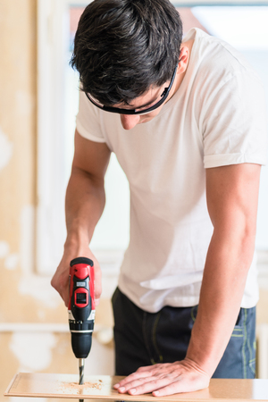 Craftsman or DIY man working with power drillの写真素材