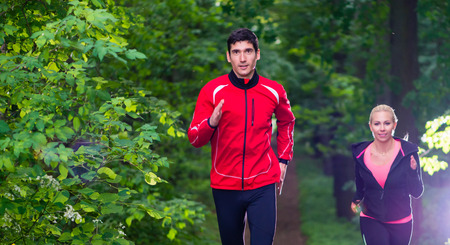 Couple running in the woods for better fitness