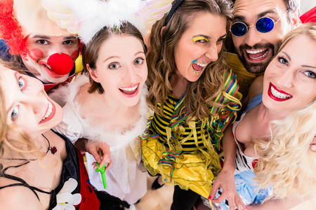 Women and men celebrating at party for new years eve or carnivalの写真素材