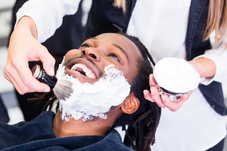 Customer at barber shop with shaving creamの写真素材