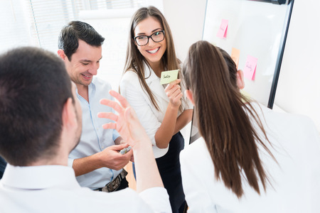 Sales Team at business meeting in office planning creative with sticky notes