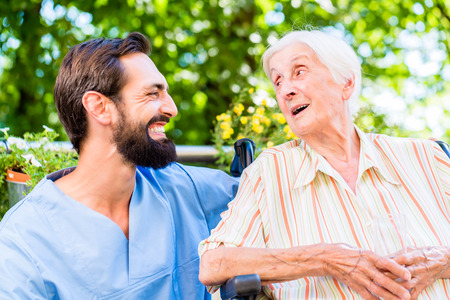 Nurse having chat with senior woman in nursing homeの写真素材
