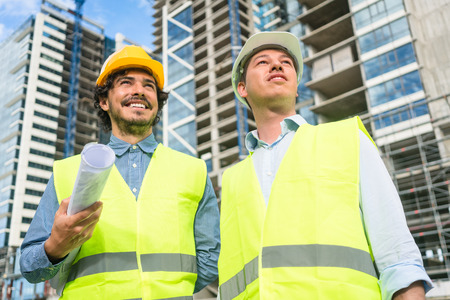 Construction engineers supervising progress of construction project