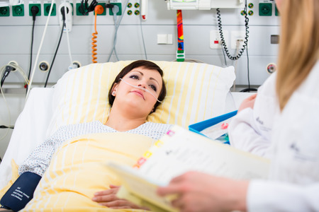 woman doctor at CCU of clinic talking with her patient about medicationの写真素材