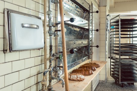Loafs of bread waiting on shelf in bakery to be sold in the shop