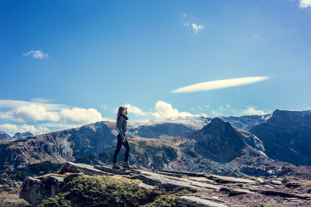 Woman admiring the view hiking the rila mountainsの写真素材