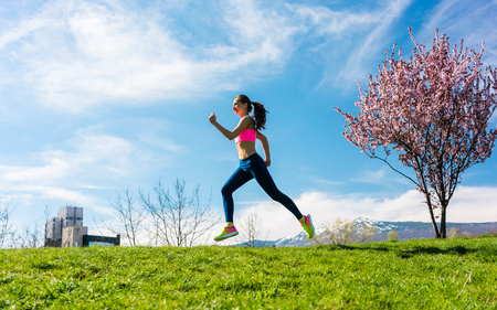 Woman sport running on hill for fitness outdoorsの写真素材