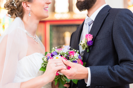 Bridal couple in church having weddingの写真素材