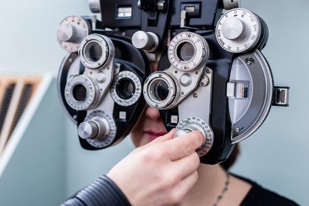 Woman at optometrist or doctor having eye sight testingの写真素材