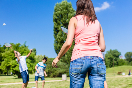 Mother and son playing badminton in park in summerの写真素材