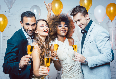 Group of party people celebrating with drinks a birthday or New years eve partyの写真素材