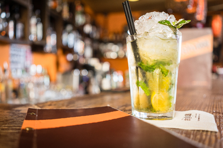 Mojito cocktail and menu on counter of barの写真素材