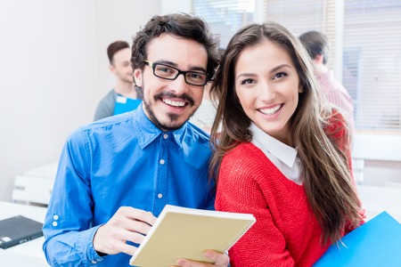 Happy students in seminar room of college or universityの写真素材