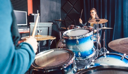 Woman receiving drum lessons from her music teacher in schoolの写真素材
