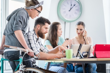 Side view of a dedicated self-employed young man analyzing a difficult task while working in a modern hub for digital nomads or independent contractorsの写真素材