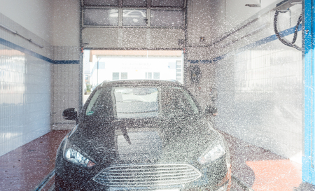 Foam being put on auto in car wash to clean itの写真素材