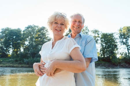 Low-angle side view portrait of a romantic senior couple in love enjoying a healthy and active...